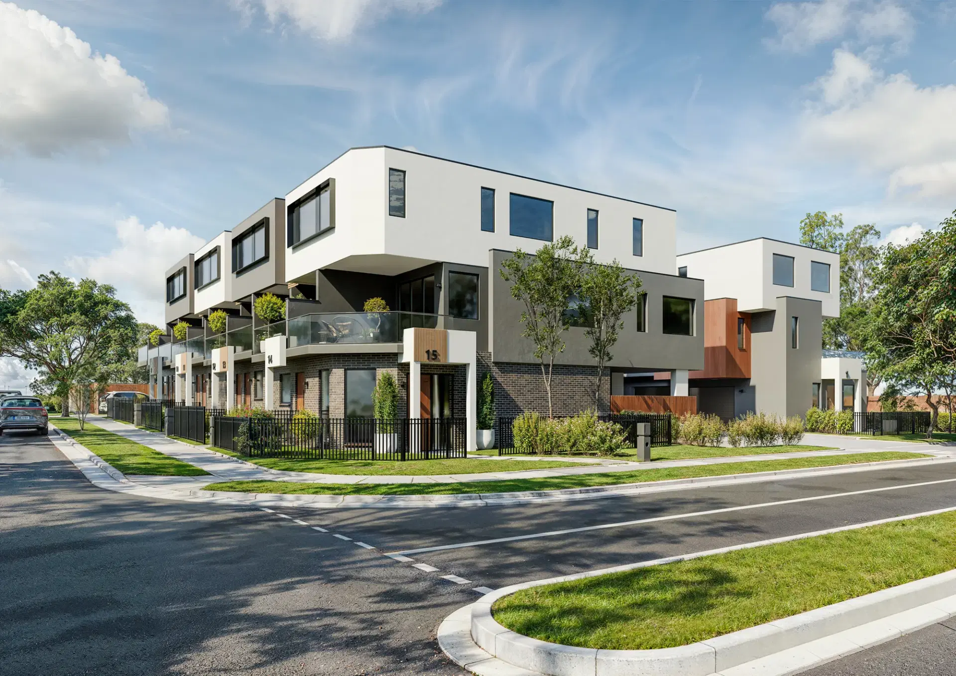 Corner elevation of 535 Boronia Road, Wantirna, with white rendered forms, timber detailing and planted terraces